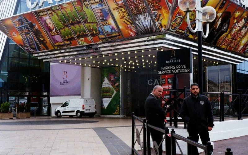 two men standing outside casino building