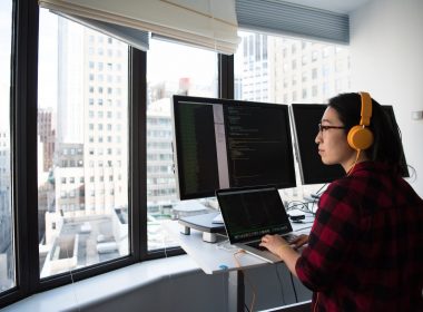 woman sitting while operating macbook pro