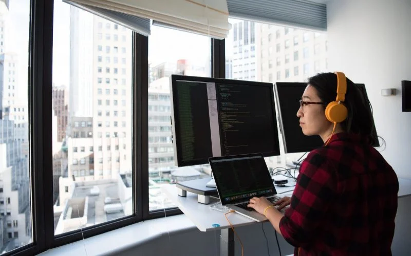 woman sitting while operating macbook pro