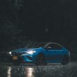 blue car on rainy night