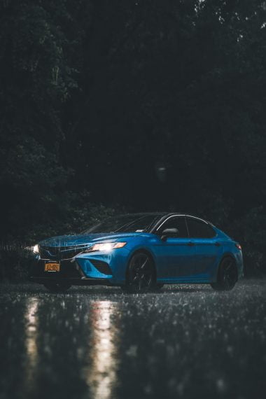 blue car on rainy night